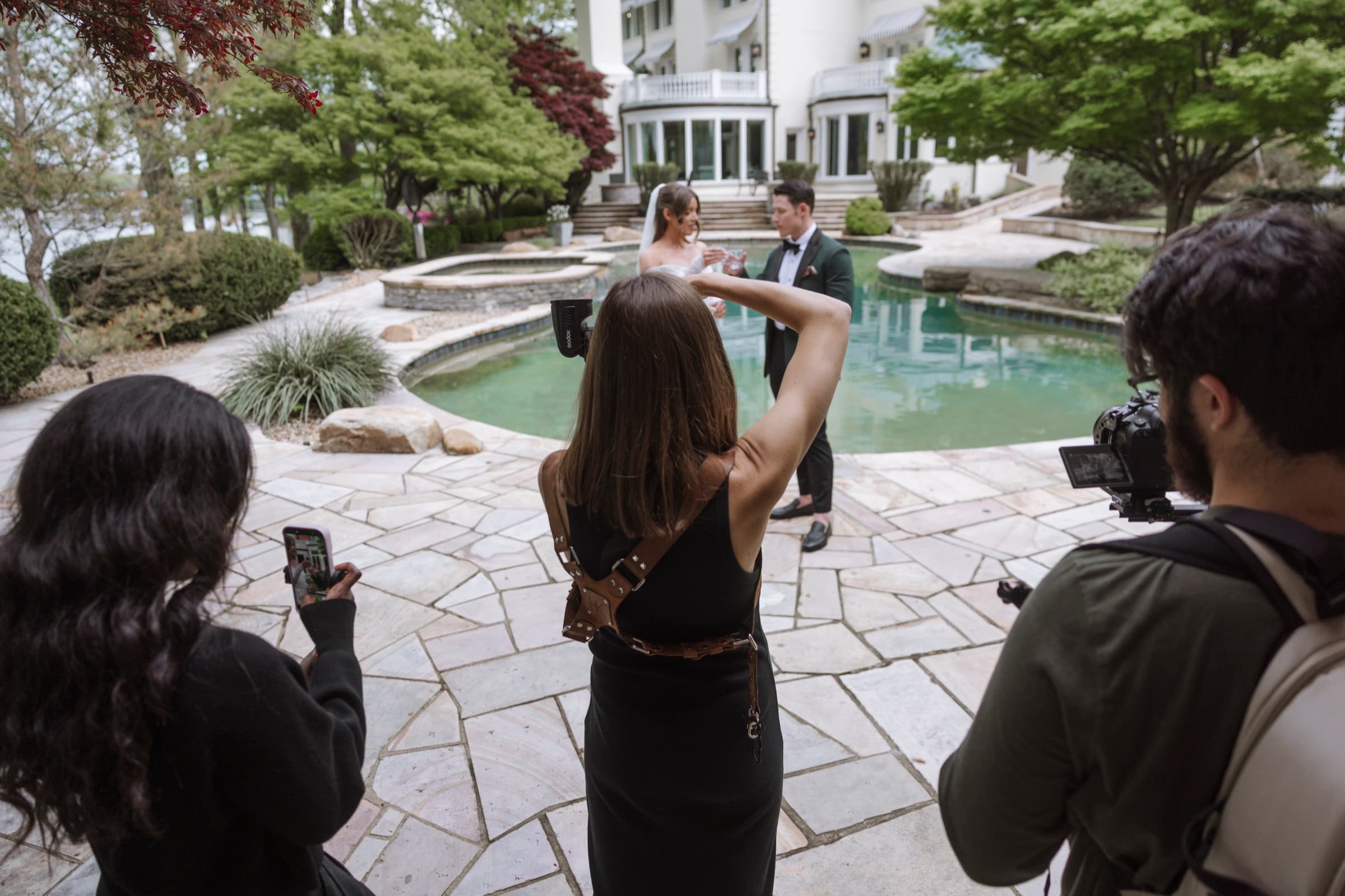 Judea filming a couple with second shooter and mansion behind