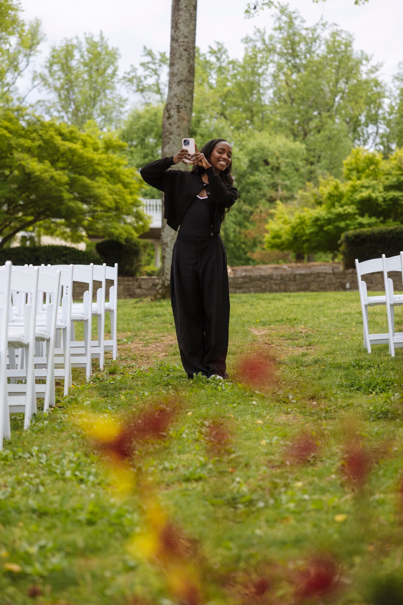Judea filming a ceremony aisle at an outdoor Nashville wedding venue