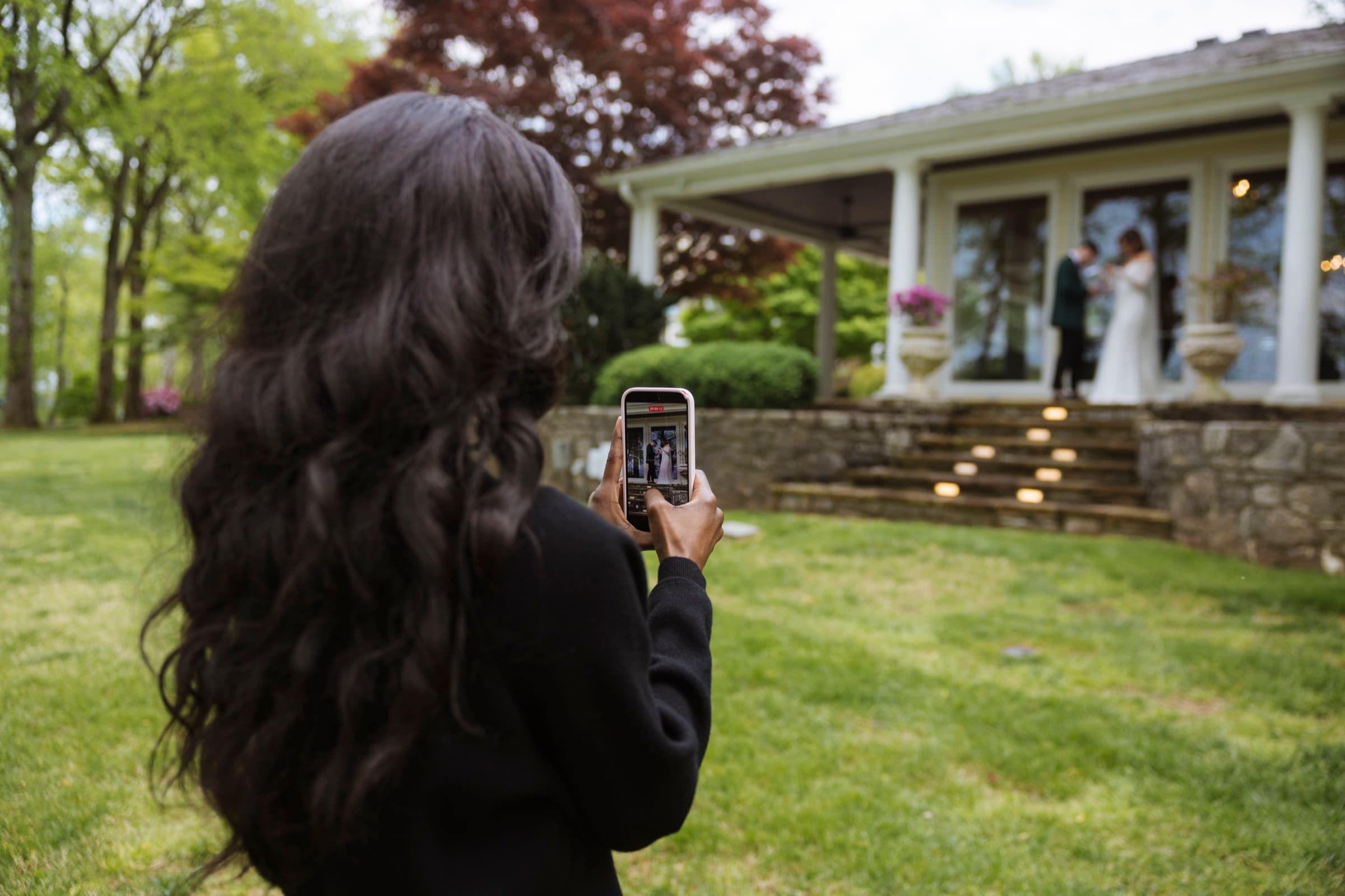 Judea filming a Nashville wedding first look on her phone gimbal
