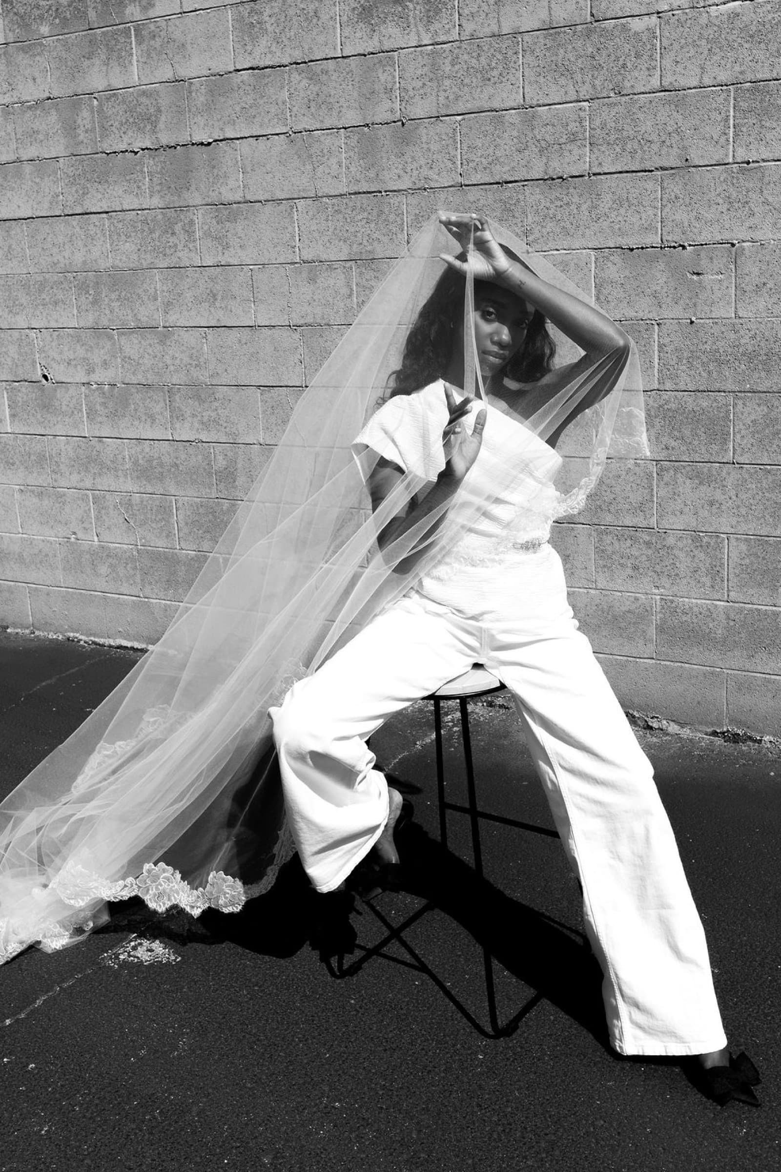 Black and white editorial of Judea with a wedding veil